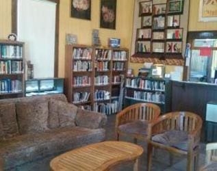 A room with several books and chairs in it.