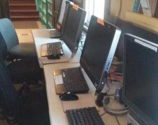 A row of computers sitting on top of tables.